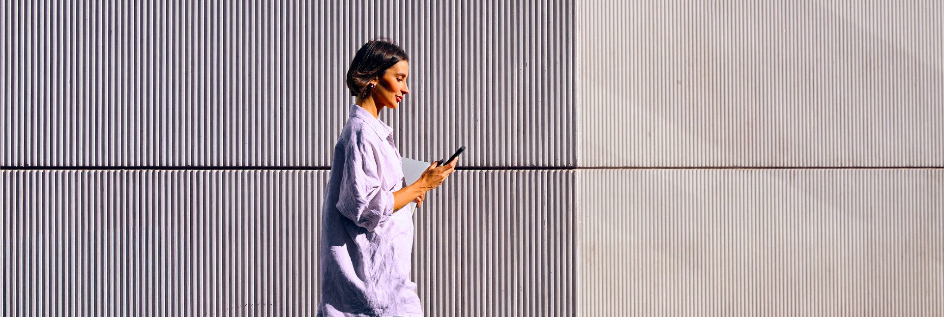 Woman walking while reading on her phone