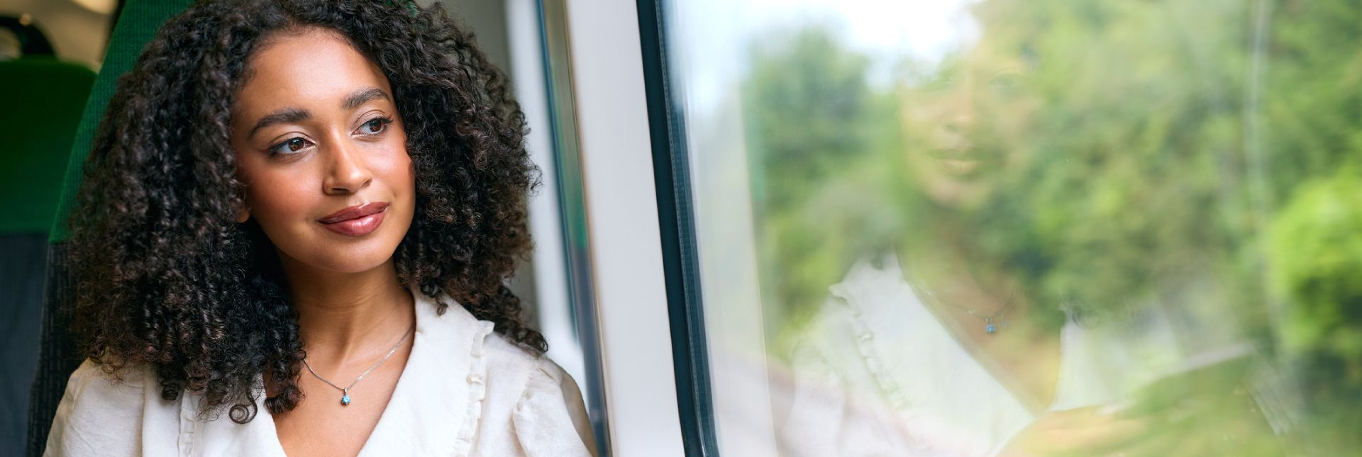 Woman looking out from the window of a train