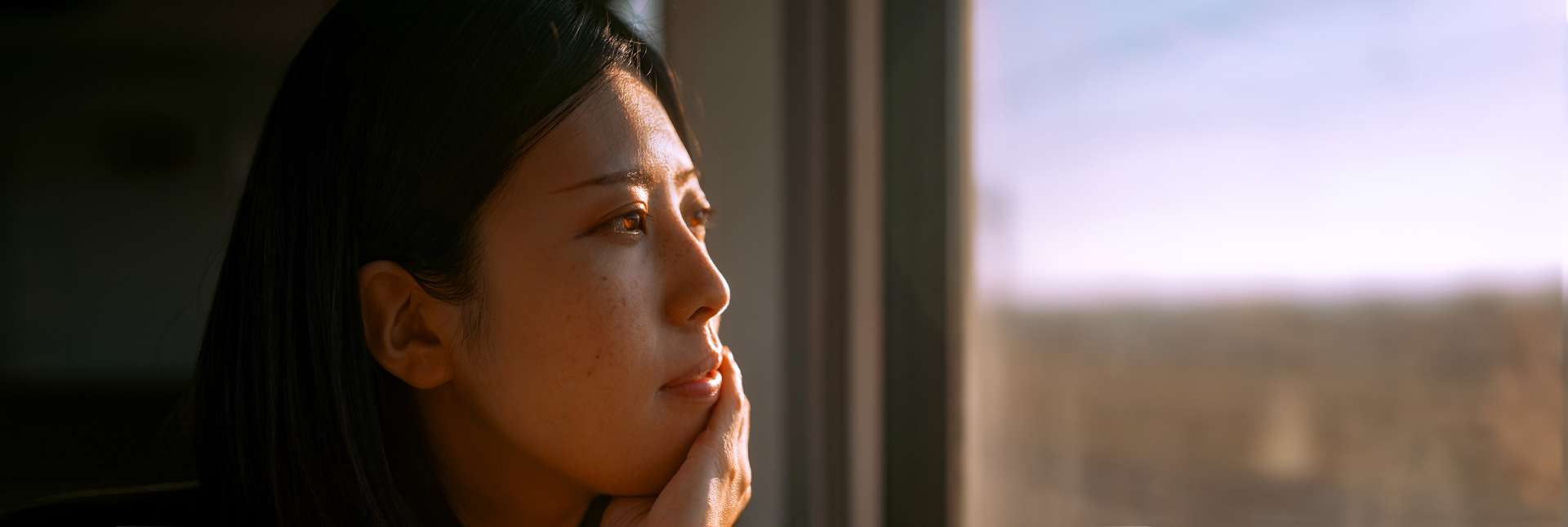 Woman looking out from the window of a train