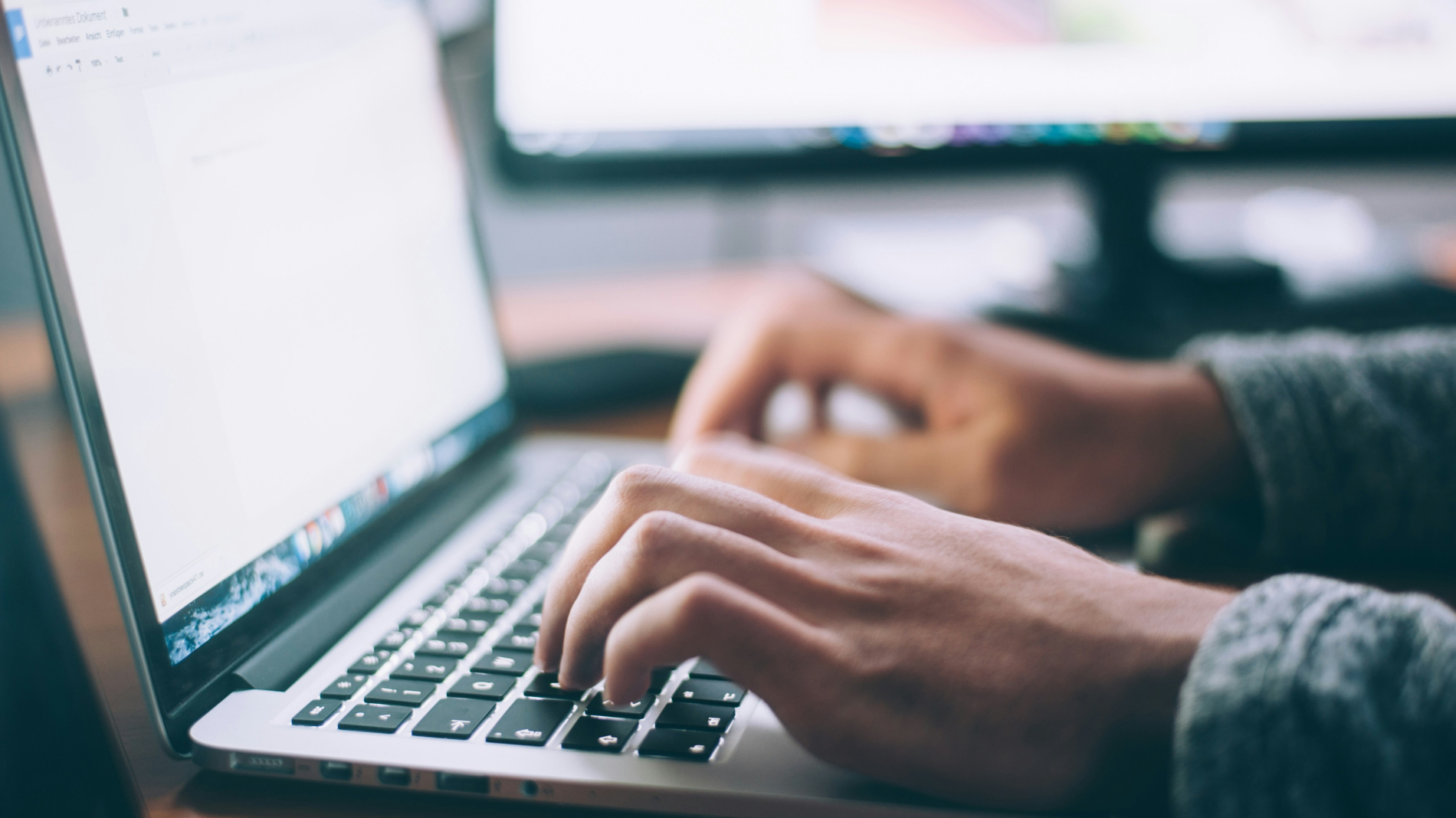 Someone typing on a laptop