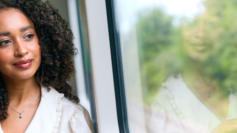 Woman looking out from the window of a train