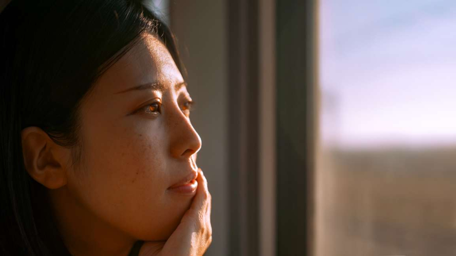 Woman looking out from the window of a train