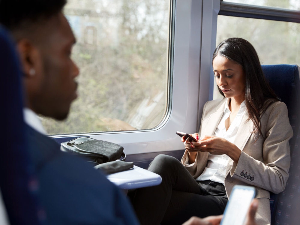 traveling-on-a-train-a-person-looks-at-a-smartphone