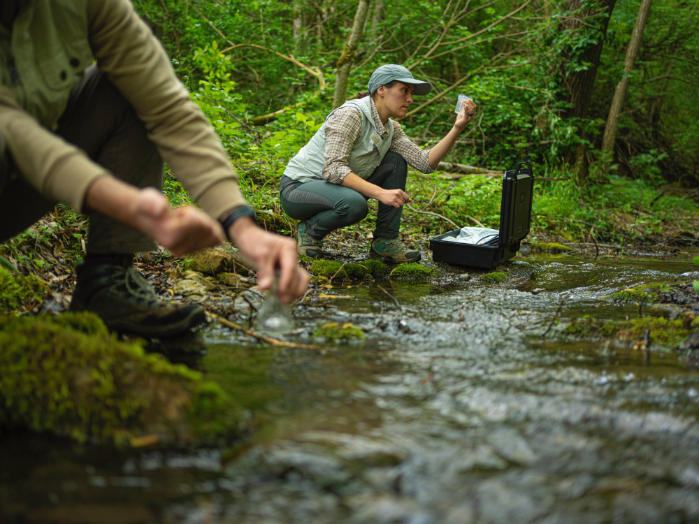 2 scientists studying a waterway
